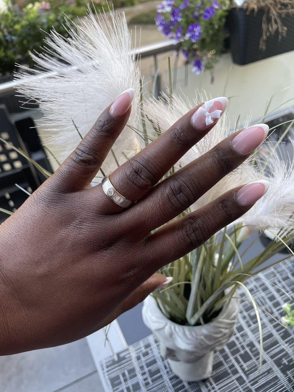 Nude almond nails with white flower