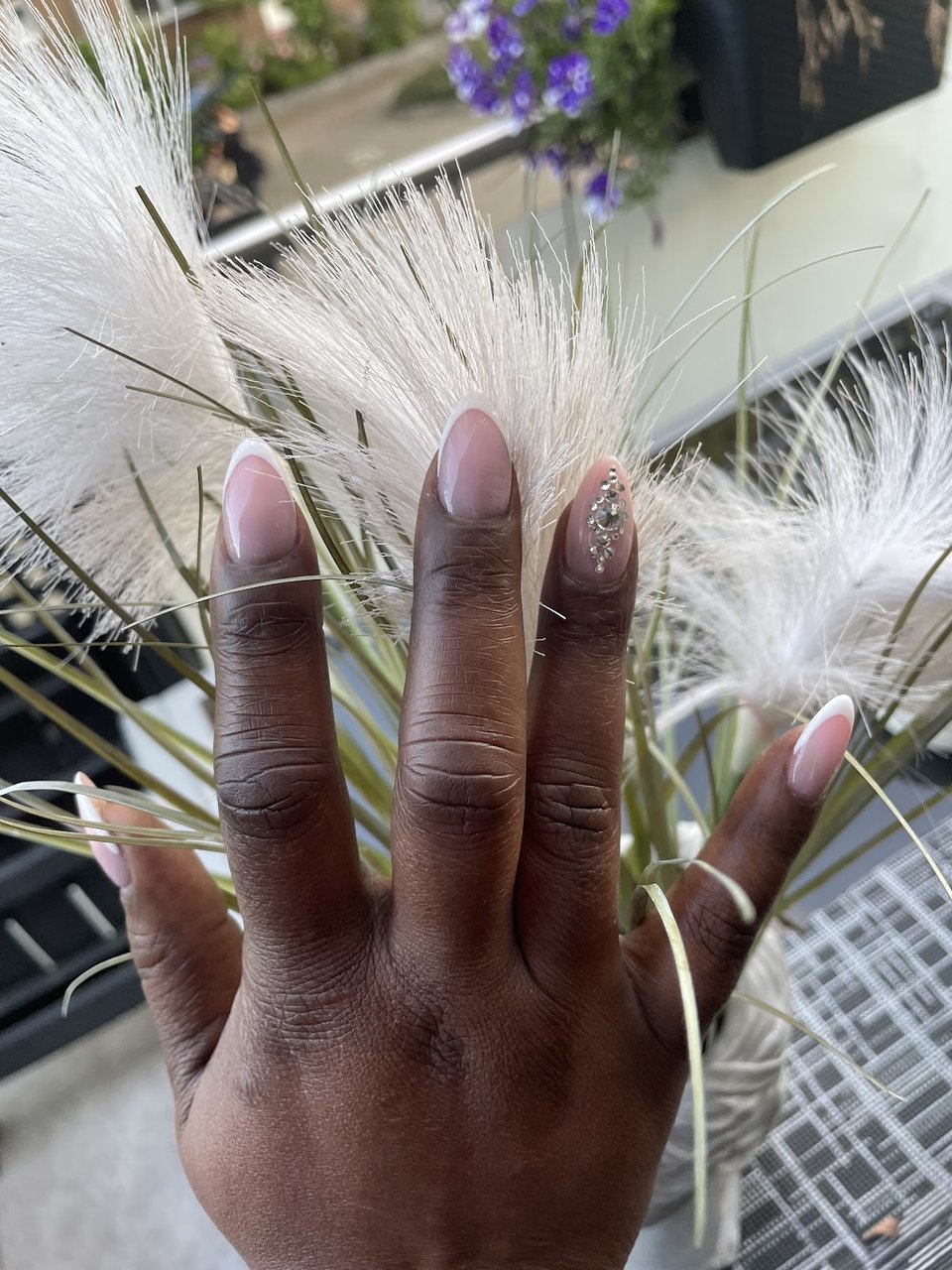 Nude almond nails with glitter accent