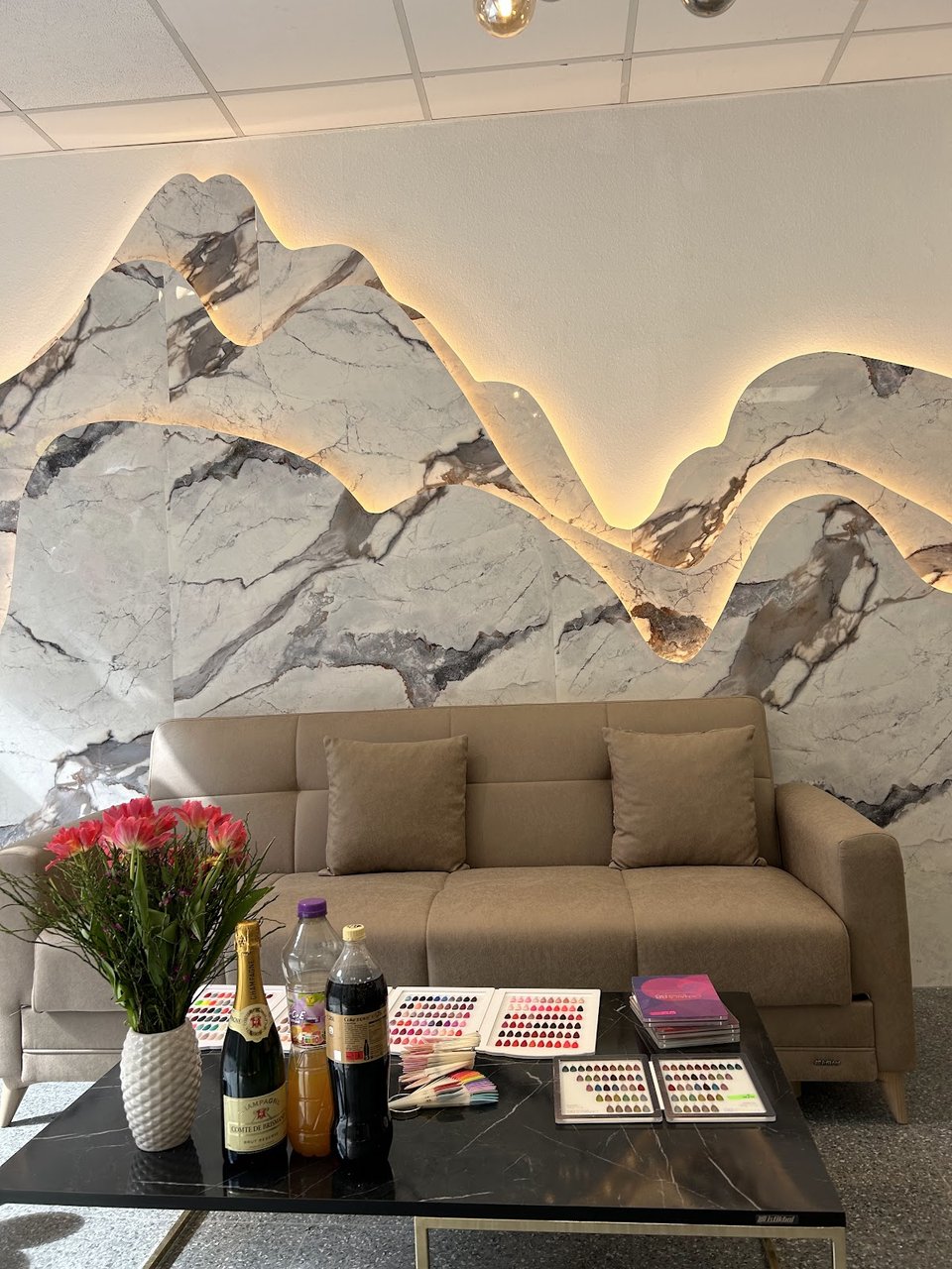 Waiting area with sofa & marble wall