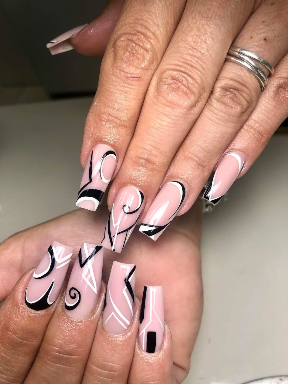 Coffin nails with black swirls